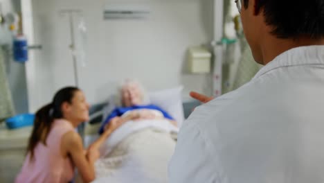 male doctor interacting with mother and daughter 4k