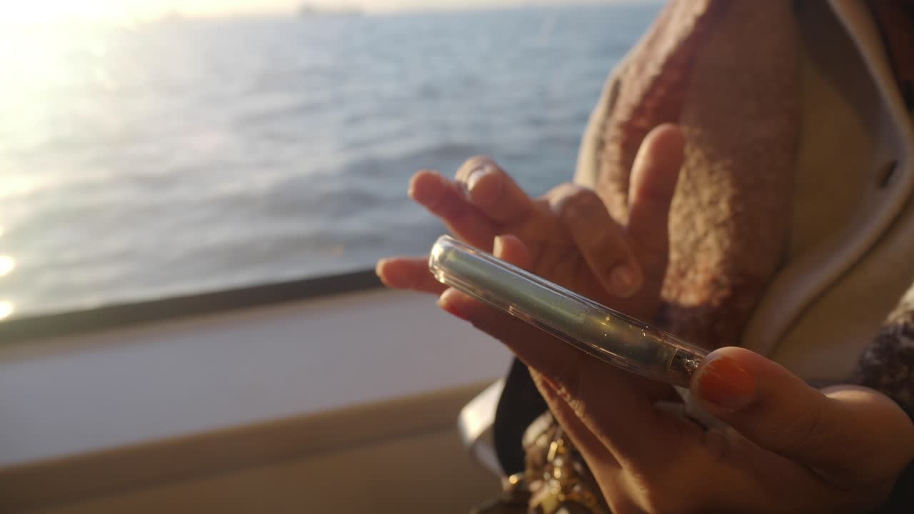 Woman using phone on a ferry
