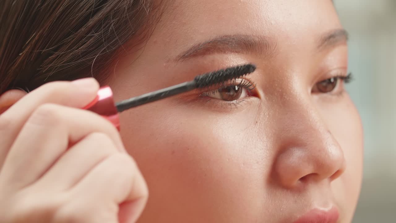 Mujer aplicando rimel