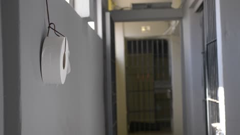 toilet paper roll hanging from wire on a mexican hispanic prison wall hallway