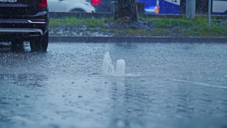 overflowing storm drain shoots water upwards during urban downpour flood