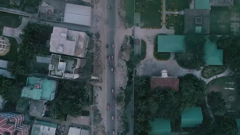 full hd drone shot of a local road where vehicles are passing