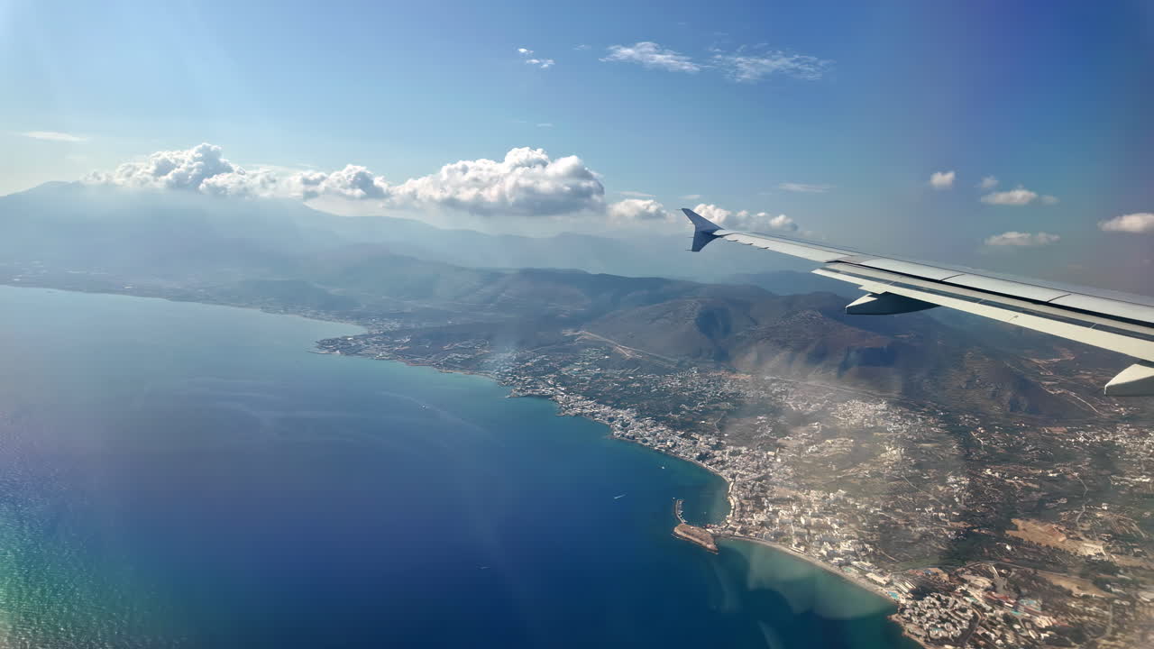 Plane wing in the sky over the sea near Crete island Greece