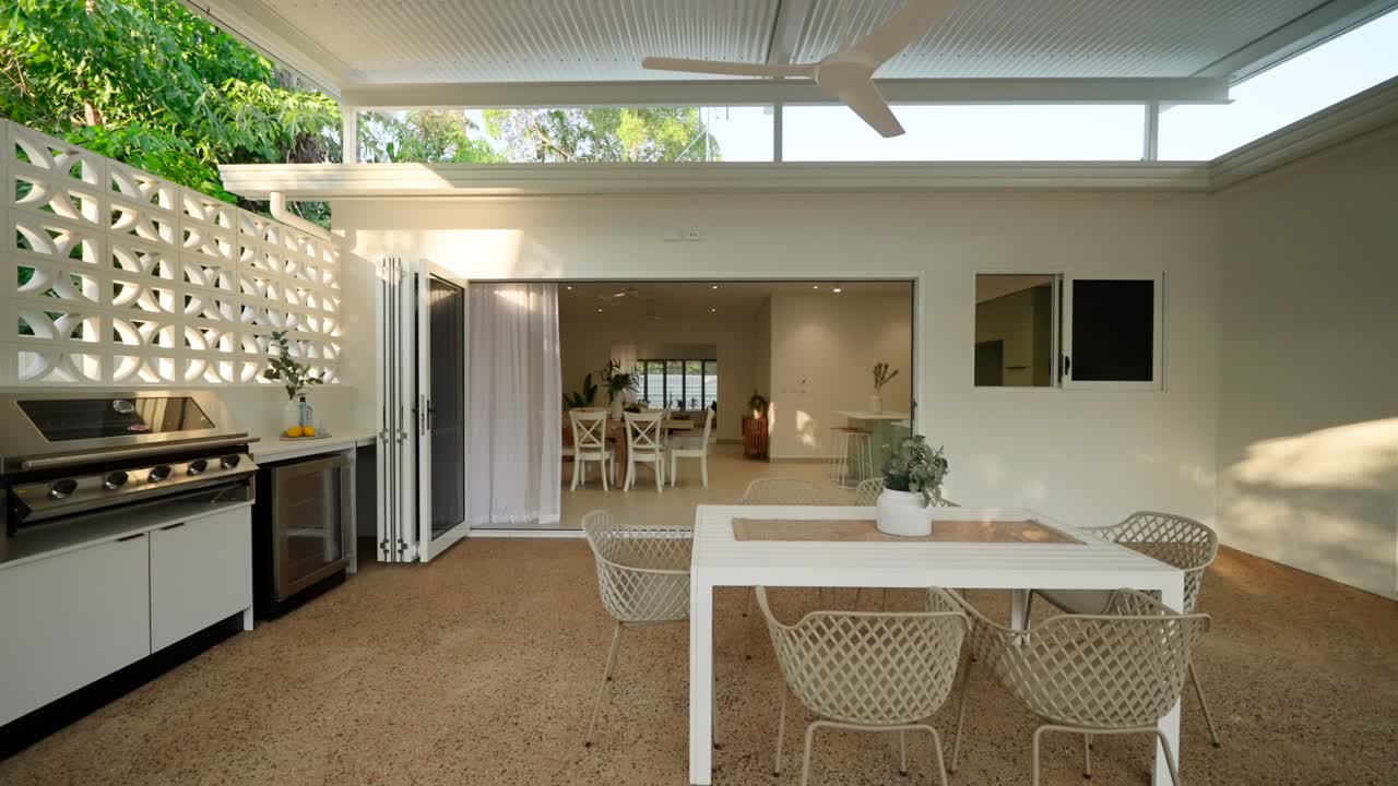 Modern outdoor patio with sleek design and stylish furniture, offering a relaxing space in a luxury small home. Exterior of house home staged for real estate.