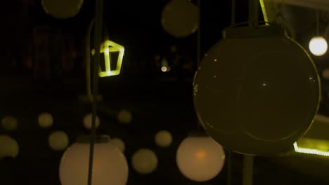 outdoor christmas decorations at night, artistic lanterns and big flashing light balls, medium shot