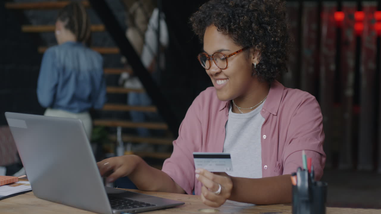 Woman using laptop and credit card for online shopping