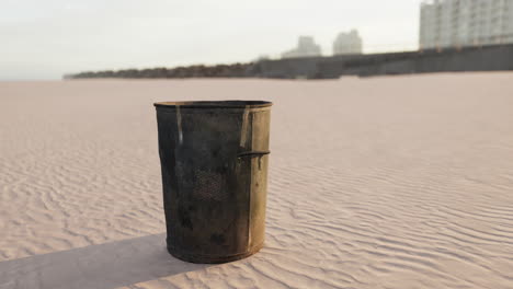 gray metal garbage bin or trash can on the beach