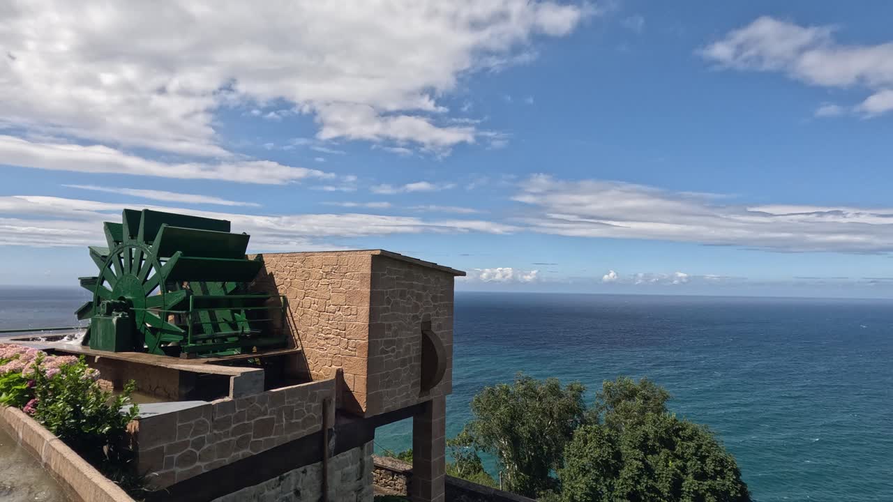 Small water wheel pushes water into seaside amusement park lazy river