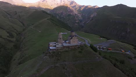 aerial establishing view above gergeti trinity church, georgia