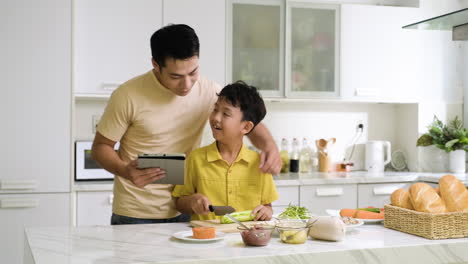 asian man and boy in the kitchen