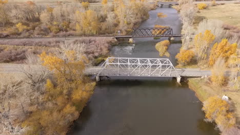 aerial view of twin bridges crossing big hole river in autumn, montana