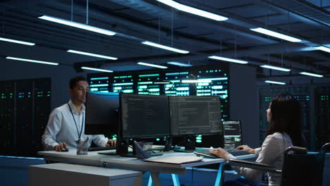 person with paraplegia working in inclusive server hub workspace, typing on pc