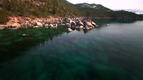 cloudy winter day sand harbor south lake tahoe boulders aerial drone california incline village crystal clear glassy turquoise water secret whale chimney kings beach shoreline forward motion