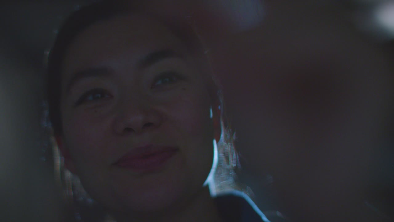 Close Up Of Woman Visiting And Interacting With Immersive Art Exhibition Backlit By Light From Projector 11