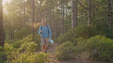 male hiker walking in forest