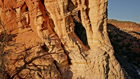 golden-hour drone view of a breathtaking natural arch set in utah’s rugged red rock terrain.