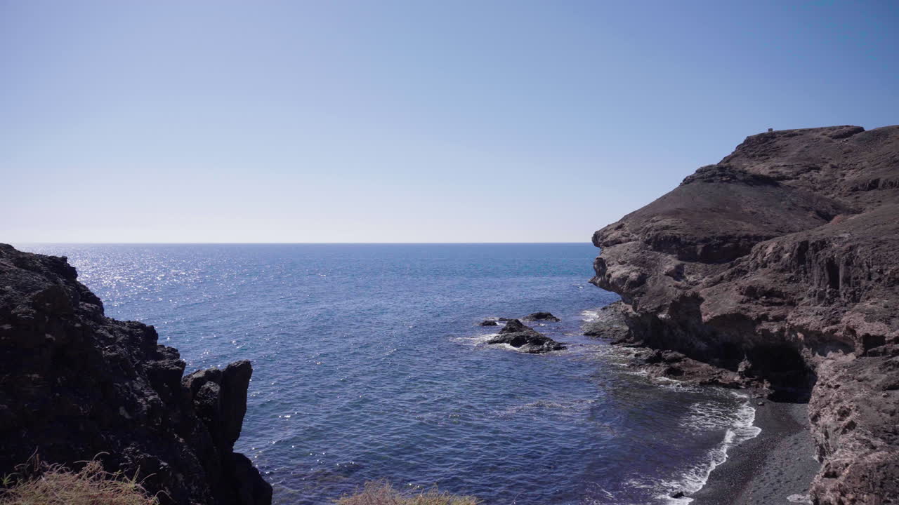 View over the coast of Fuerteventura, Canary Islands with waves coming in in front of rock formations