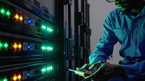 it technician performing maintenance on server racks