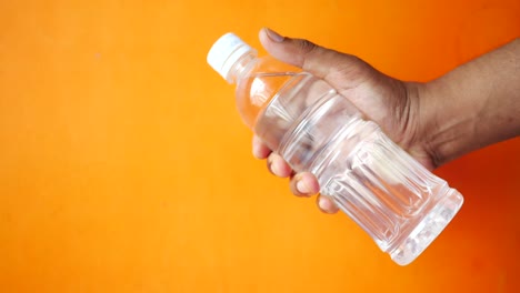 hand holding a water bottle