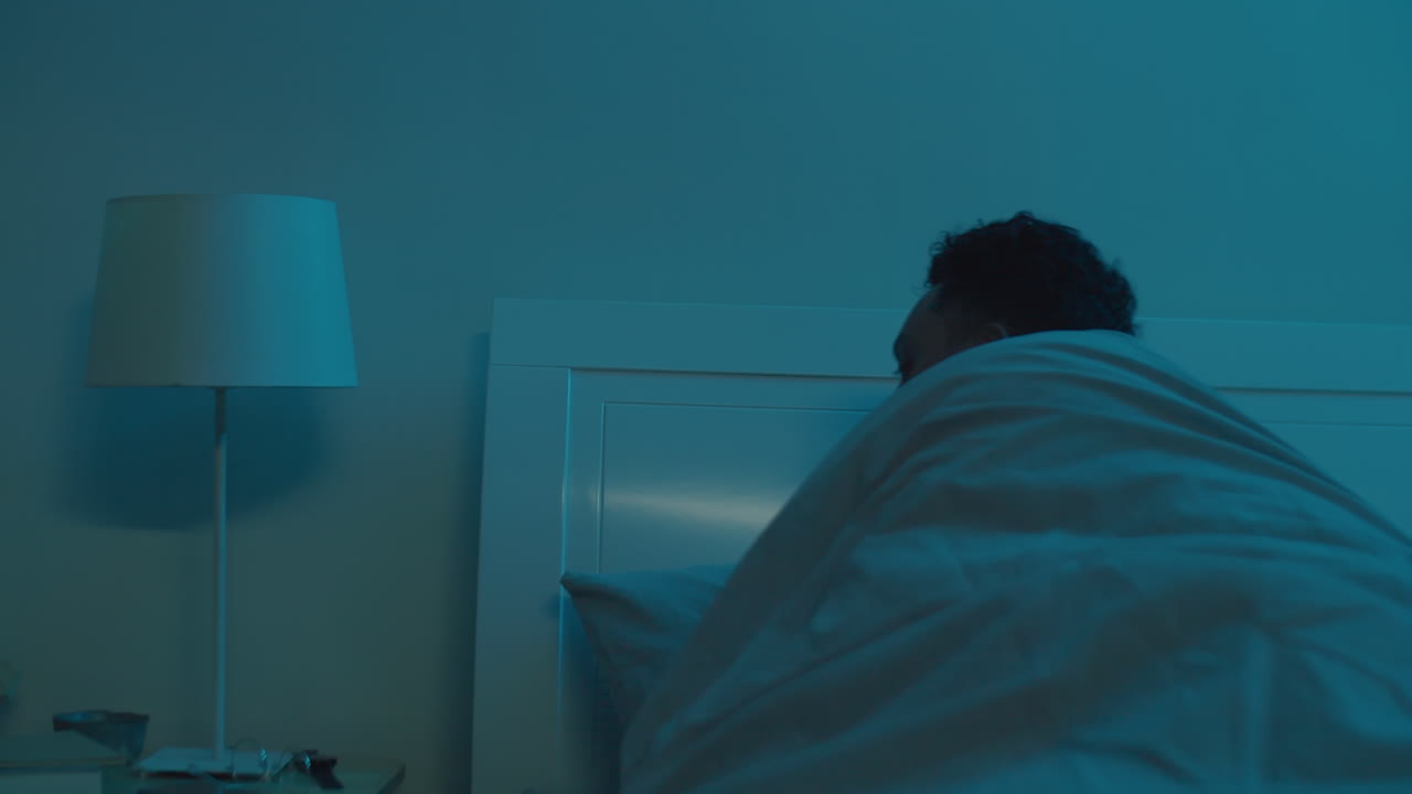 Man Using Tablet and Going to Sleep in Evening