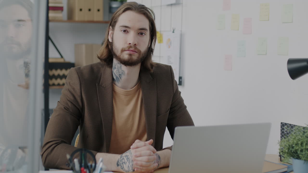 Man Sitting at a Desk in an Office