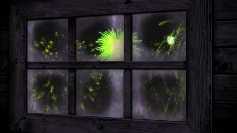 animation of window with green christmas and new year fireworks exploding in night sky