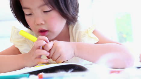 girl colouring in a colouring book