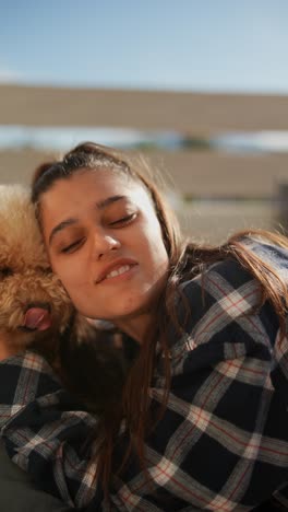 woman cuddling with her poodle