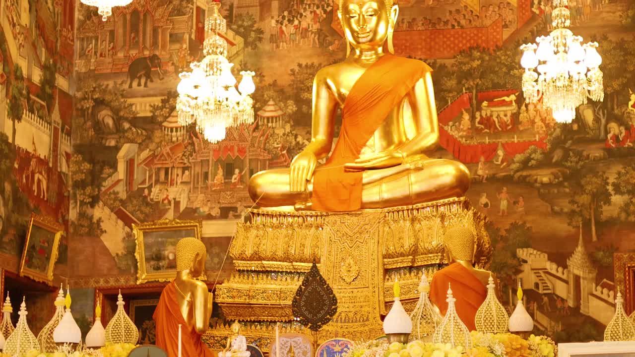 A serene golden Buddha statue in Wat Arun, Bangkok, surrounded by vibrant flowers and ornate decorations under warm lighting