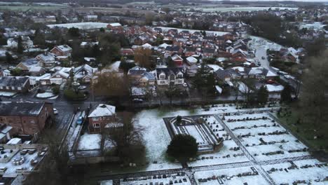 Snowy-aerial-village-residential-neighbourhood-Winter-frozen-North-West-houses-and-roads-static-right-pan-shot