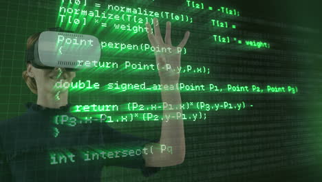Wearing VR headset, person interacting with virtual environment over green coding screen