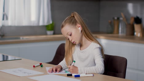 girl drawing in kitchen