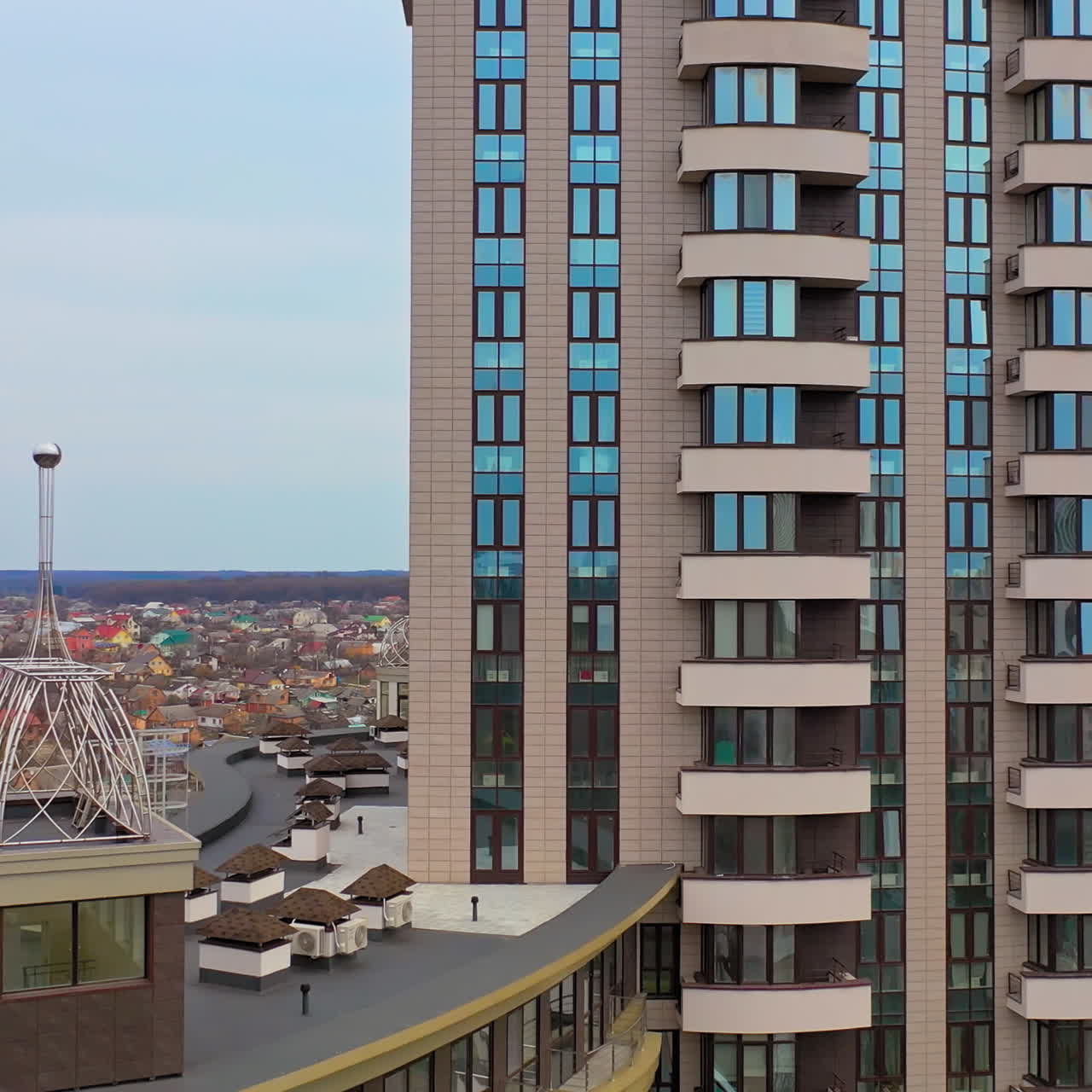 Multy-storey building with new design for high structure in the city. Aerial view of a beautiful high-rise public housing apartments. Camera moves right.