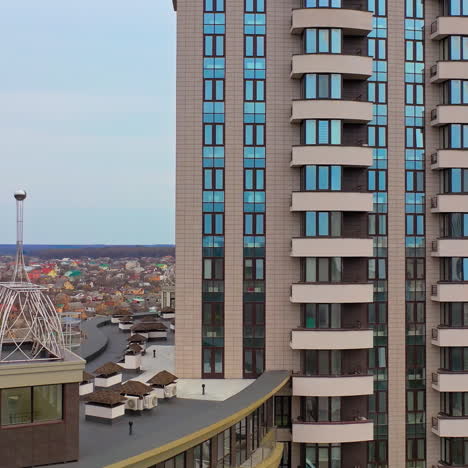 multy-storey building with new design for high structure in the city. aerial view of a beautiful high-rise public housing apartments. camera moves right.
