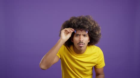man with afro and glasses showing different expressions