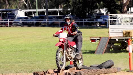 motorcyclist performing log jump in outdoor event