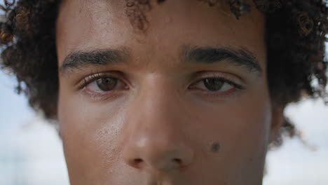 Focused-guy-staring-lens-outdoors-extreme-closeup.-Model-looking-camera-vertical