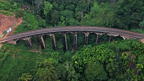 stunning aerial drone footage of the famous nine arches bridge in ella, sri lanka.