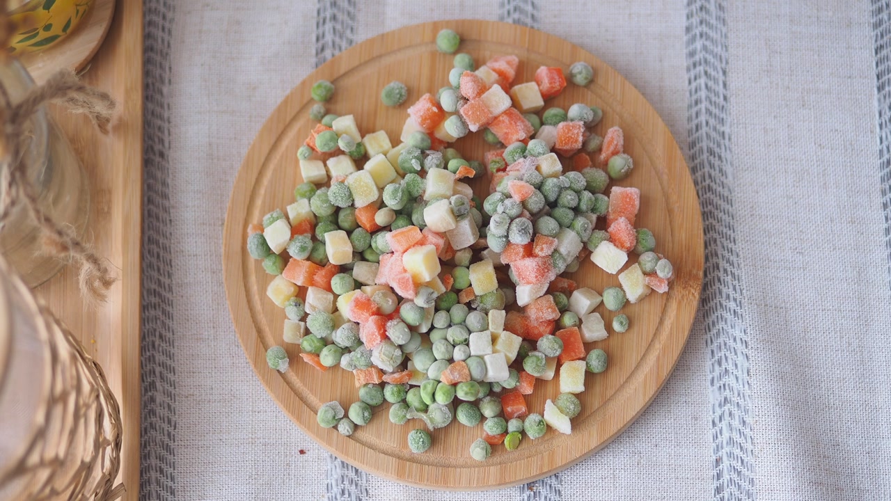 Assortment of Frozen Vegetables on Round Wooden Board