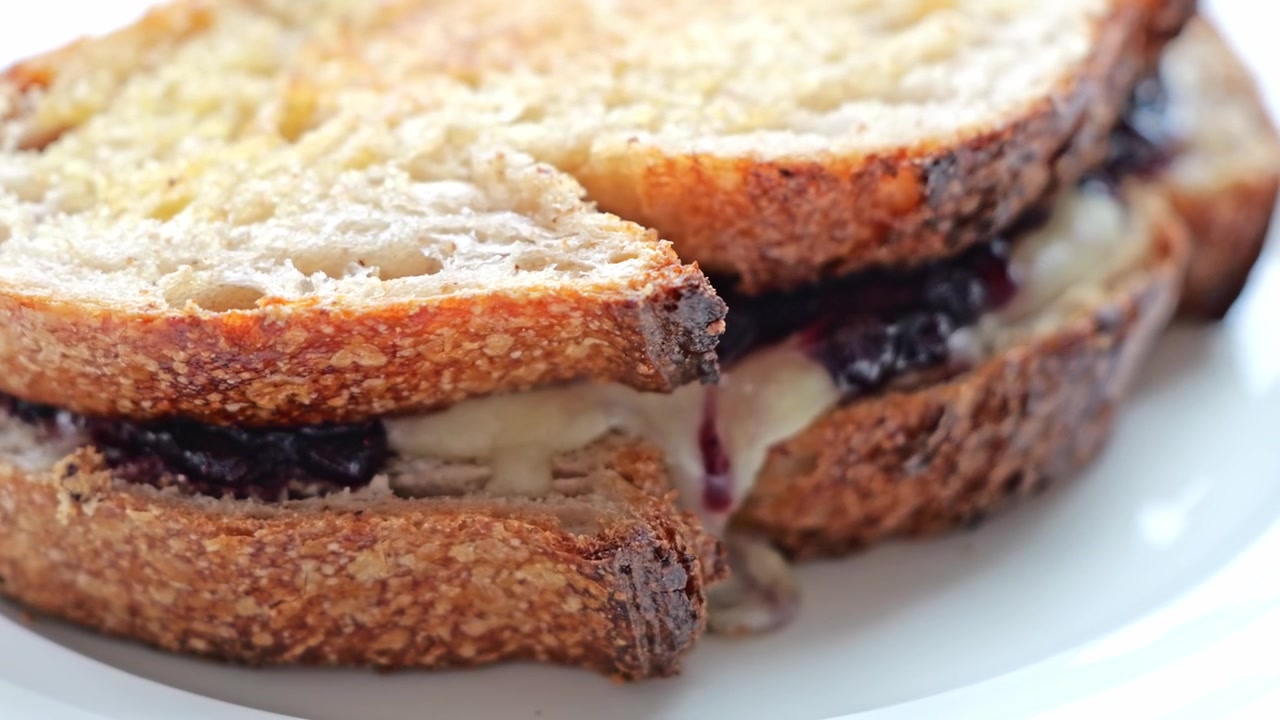 Toasted Bread Sandwich with Berry Filling and Melted Cheese Served on Plate