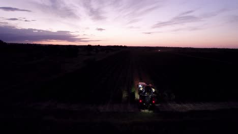 Aerial-shot-of-farmers-starting-their-early-day-harvesting-grapes-in-southern-France