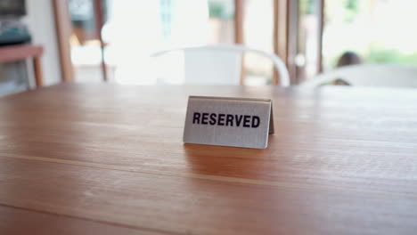 close up of reserved sign on the cafe table restaurant during daytime