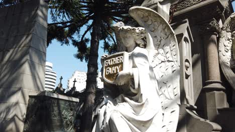 angel statue at father fahy's grave in cemetery