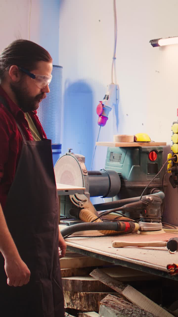 Craftsman Putting on Safety Gloves in Woodworking Workshop