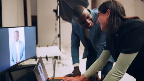 two people looking at a computer screen in a studio