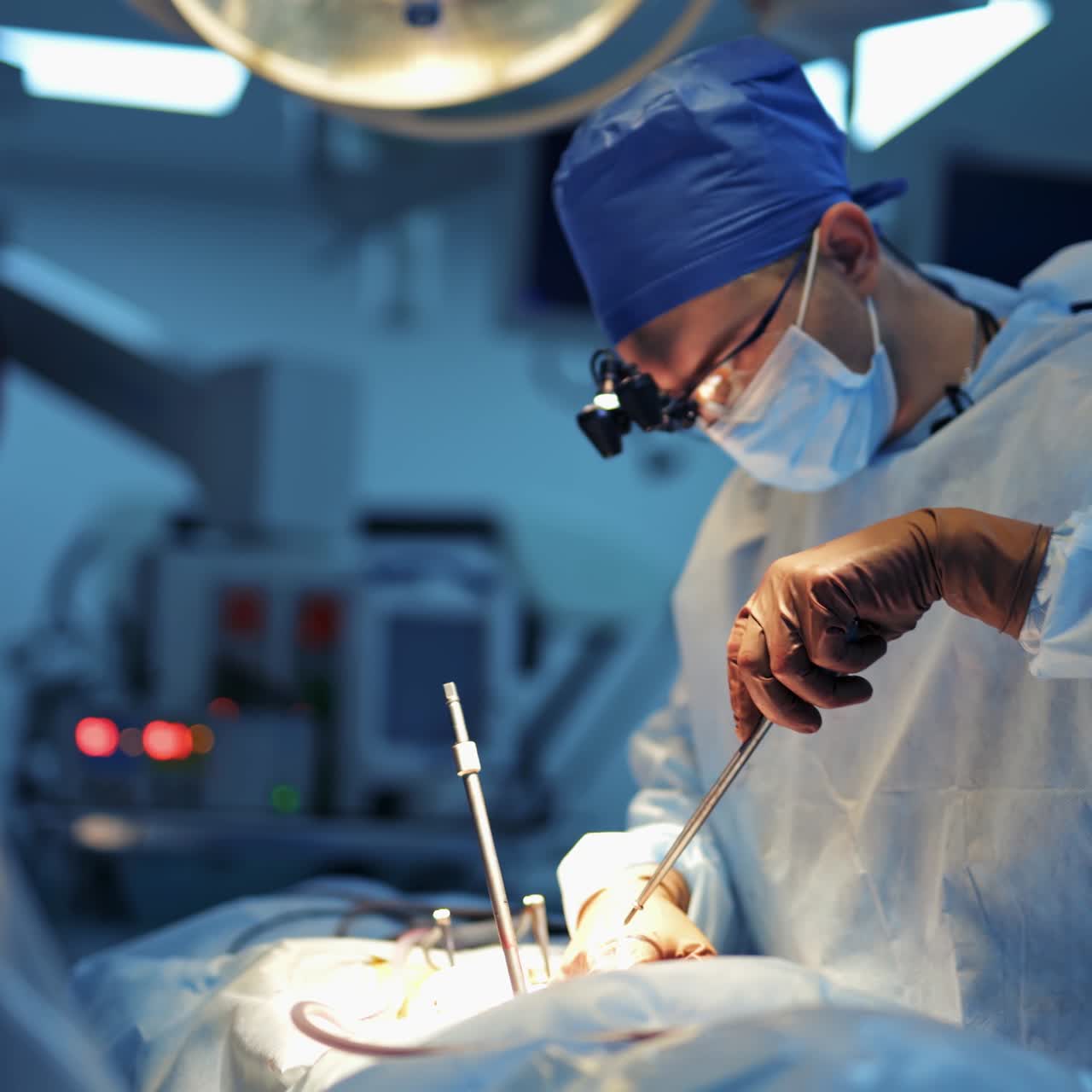 Medical team performing surgical operation in bright modern surgery room. Operating theatre. Modern equipment in clinic