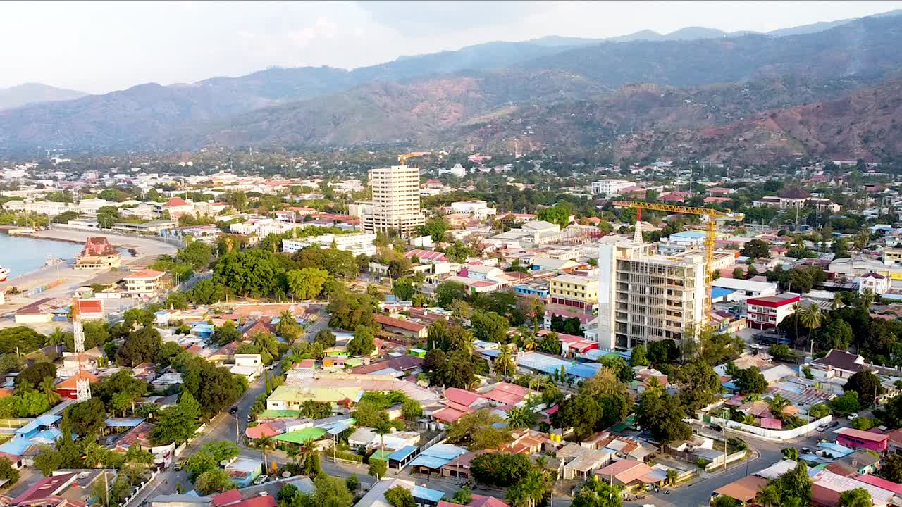 Static aerial drone landscape view of capital city of Dili, Timor-Lest in Southeast Asia with new high rise building developments and residential houses