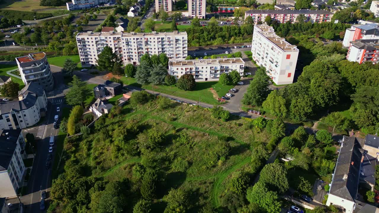 Residential apartment buildings and green spaces, Laval, France. Aerial drone forward