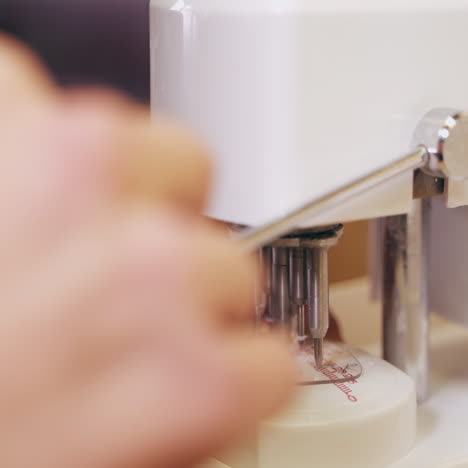 specialist working with lens for glasses on optical machine. eyeglasses production. modern equipment for making lens.