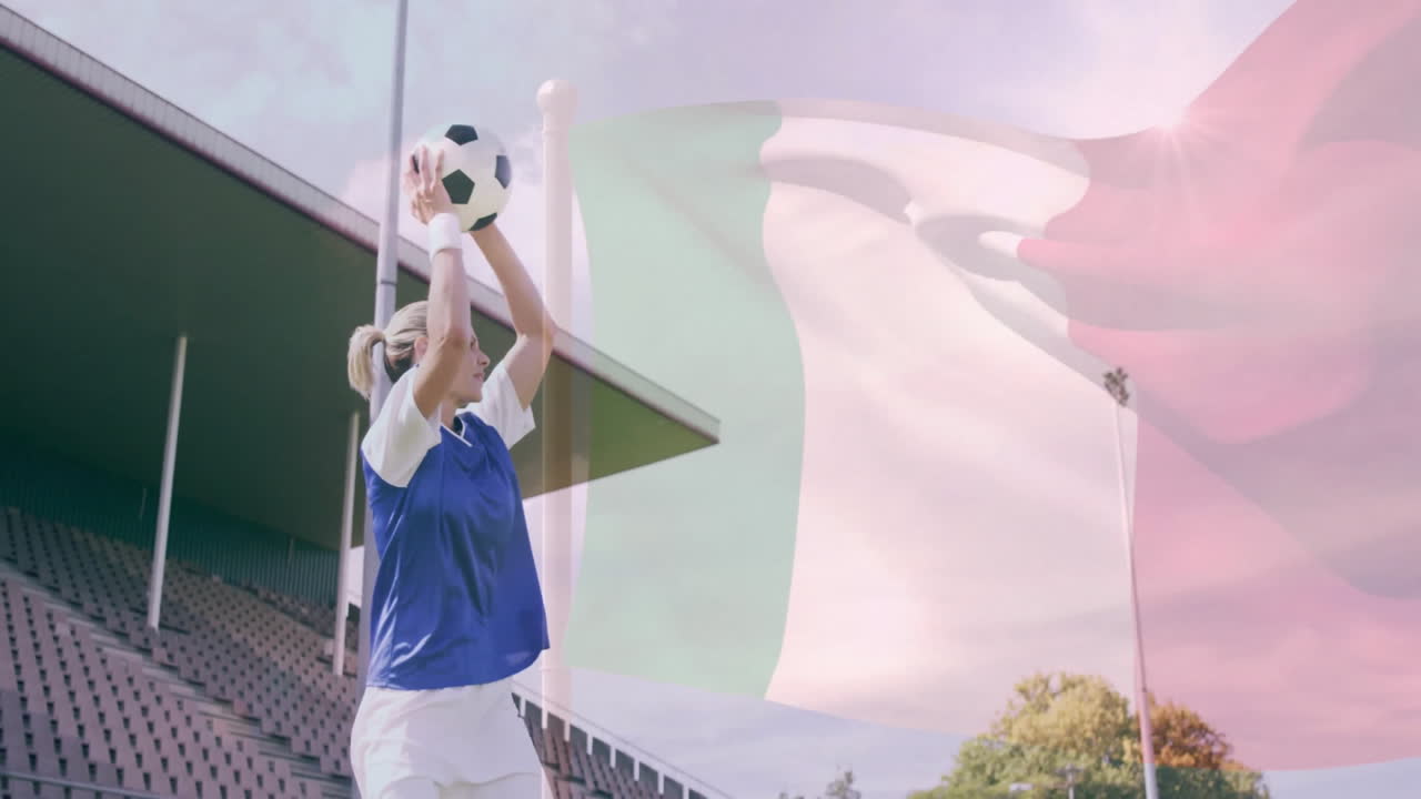 Holding soccer ball with Italian flag, player standing at outdoor stadium